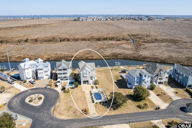 bird's eye view featuring a residential view and a water view