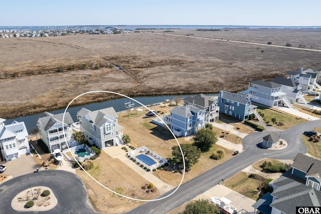 aerial view featuring a water view and a residential view