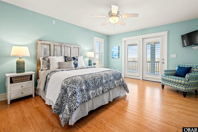 bedroom featuring visible vents, wood finished floors, baseboards, ceiling fan, and vaulted ceiling