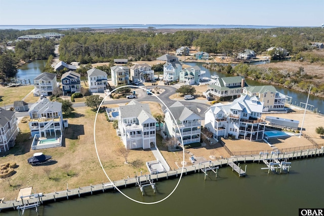 birds eye view of property with a residential view and a water view