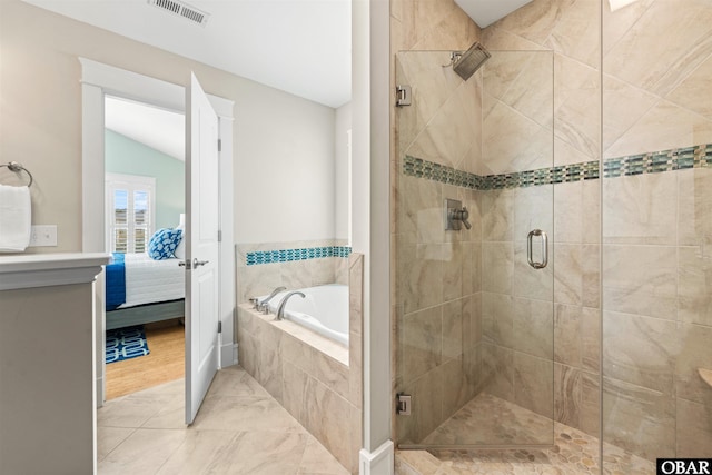 bathroom featuring visible vents, a shower stall, vaulted ceiling, ensuite bathroom, and a bath