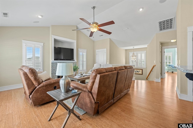 living area with light wood finished floors, visible vents, and baseboards