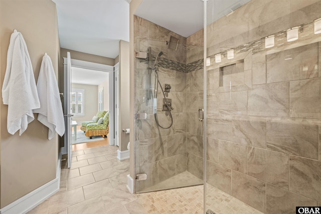 bathroom with baseboards and a shower stall