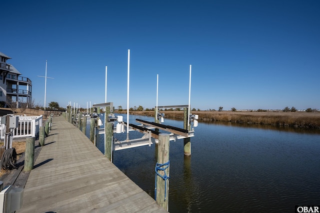 view of dock with a water view and boat lift