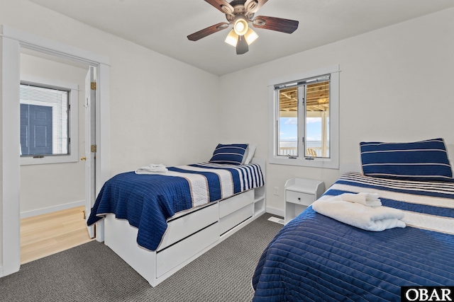 bedroom with a ceiling fan and baseboards