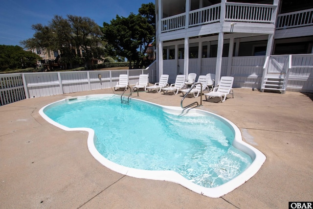 view of swimming pool with a patio, fence, and a fenced in pool