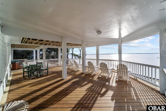 wooden terrace featuring a water view