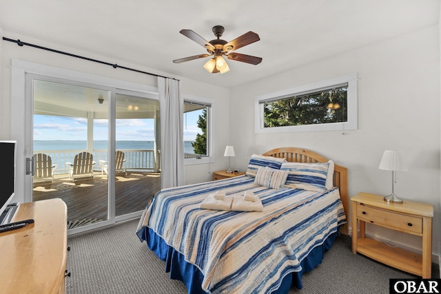 carpeted bedroom with ceiling fan, access to outside, and a water view