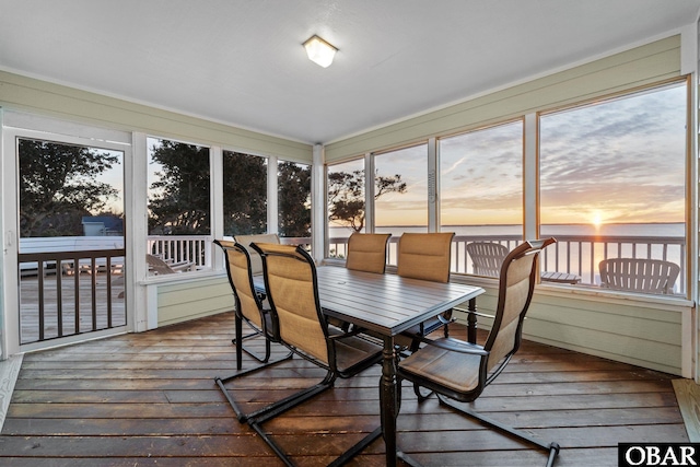 sunroom / solarium featuring a water view and plenty of natural light