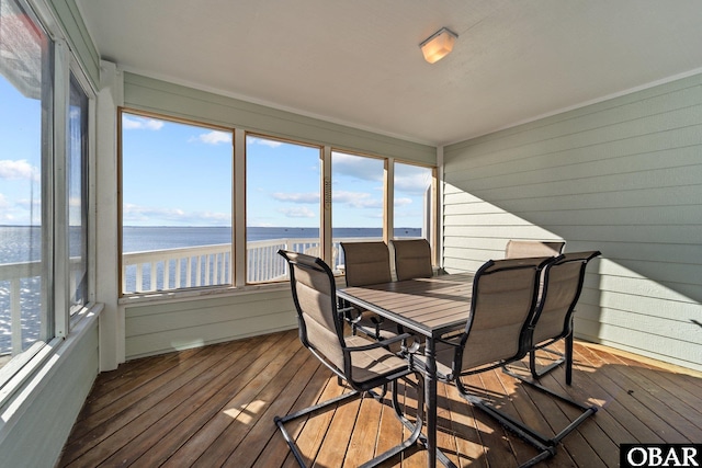 sunroom / solarium with a water view and lofted ceiling