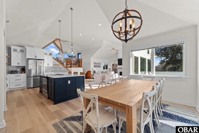 dining room featuring baseboards, an inviting chandelier, stairs, light wood-style floors, and recessed lighting