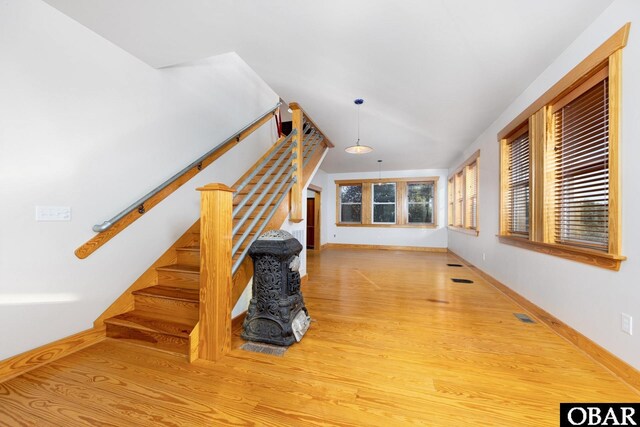 interior space featuring baseboards, visible vents, and wood finished floors