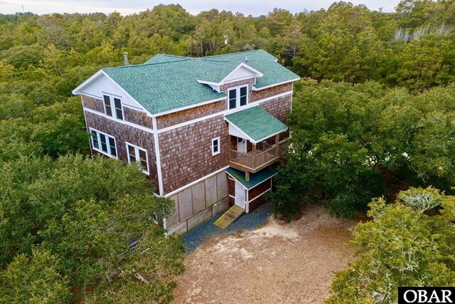 drone / aerial view featuring a wooded view