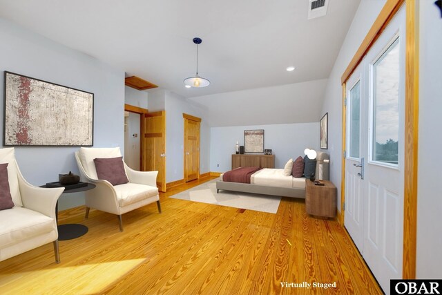 bedroom featuring baseboards, visible vents, vaulted ceiling, and light wood finished floors