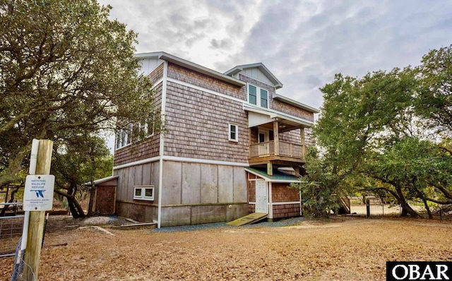 back of property with a balcony