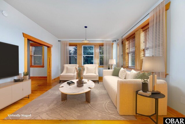 living room featuring light wood finished floors and baseboards