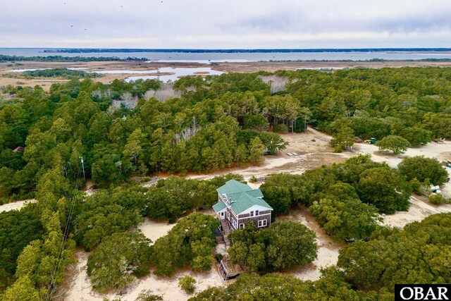 drone / aerial view with a water view and a wooded view