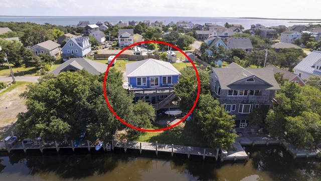 bird's eye view featuring a water view and a residential view