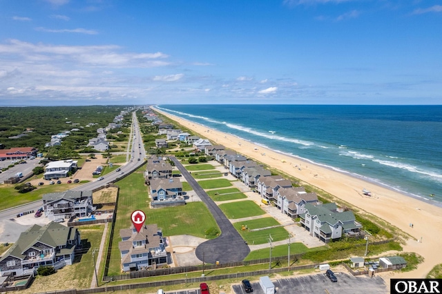 drone / aerial view featuring a beach view and a water view