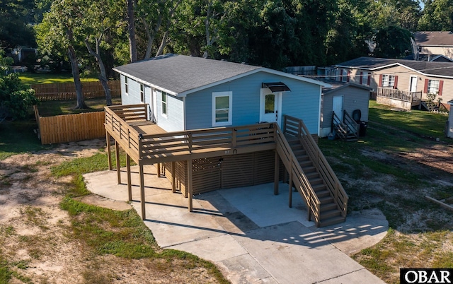 717 Fernando St Lot 3, Manteo, NC 27954 - back of house featuring a wooden deck, a shingled roof, driveway, and stairs
