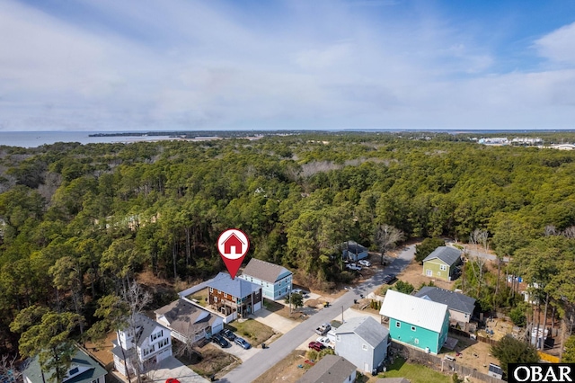 drone / aerial view with a water view and a forest view