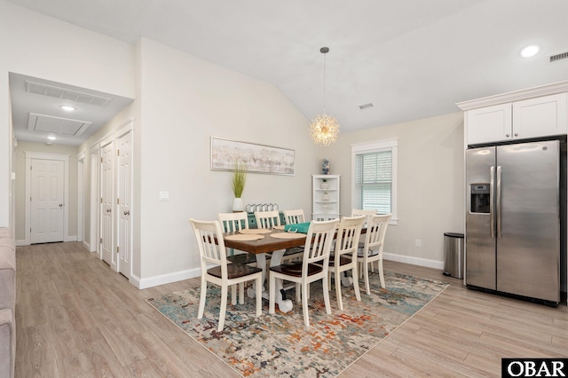 dining space featuring lofted ceiling, baseboards, visible vents, and light wood finished floors