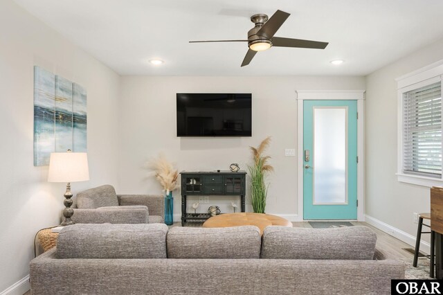 living area with recessed lighting, baseboards, a ceiling fan, and wood finished floors