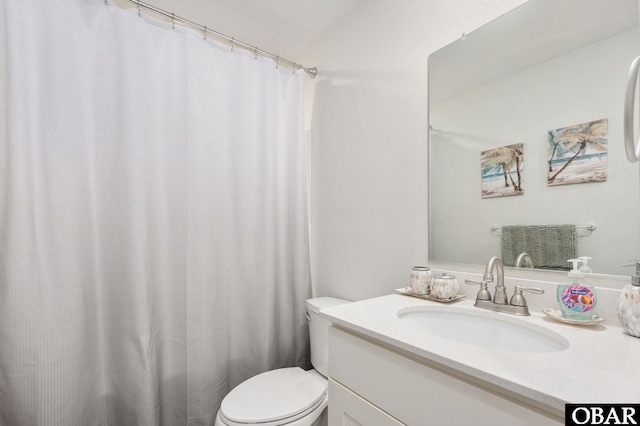 bathroom featuring toilet and vanity