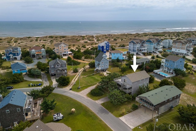 birds eye view of property with a water view and a residential view