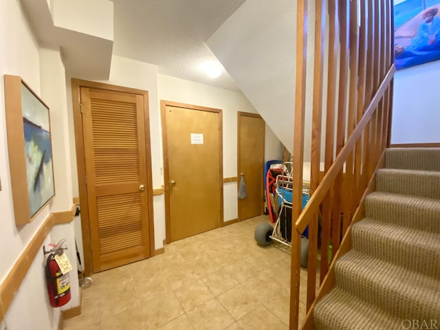 interior space featuring stairs and a textured ceiling