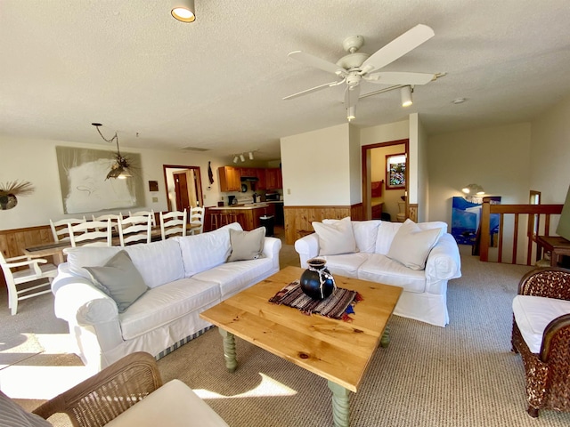 26823 Colony Dr Lot 41, Salvo, NC 27972 - living room with light carpet, a wainscoted wall, wooden walls, a ceiling fan, and a textured ceiling