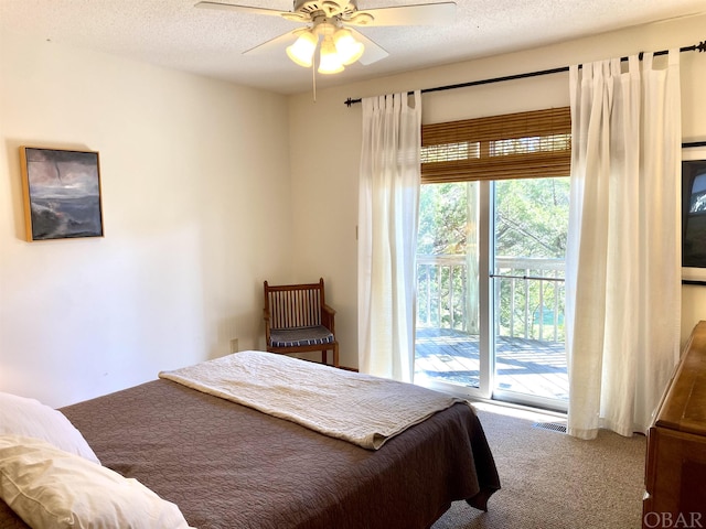 carpeted bedroom with access to exterior, visible vents, ceiling fan, and a textured ceiling