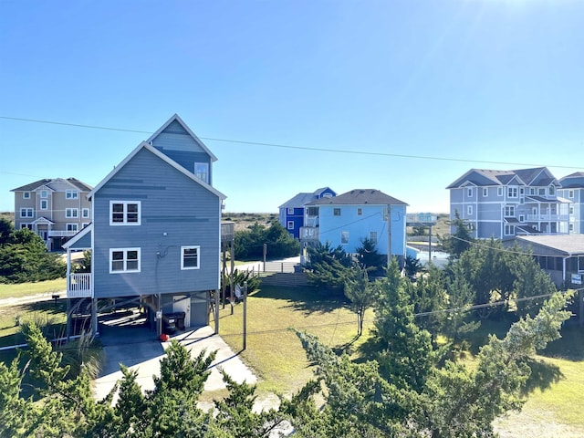 view of property exterior with driveway and a carport