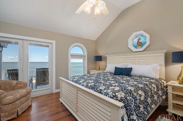 bedroom with lofted ceiling, ceiling fan, dark wood-style flooring, a water view, and access to outside