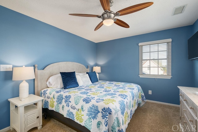 bedroom with baseboards, visible vents, a ceiling fan, light colored carpet, and a textured ceiling