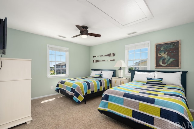 carpeted bedroom featuring a ceiling fan, visible vents, and multiple windows