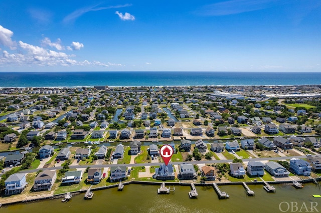 drone / aerial view featuring a water view and a residential view