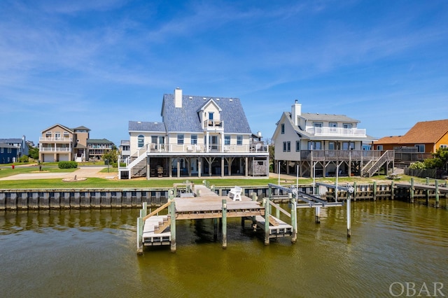 view of dock featuring a deck with water view, boat lift, and stairs