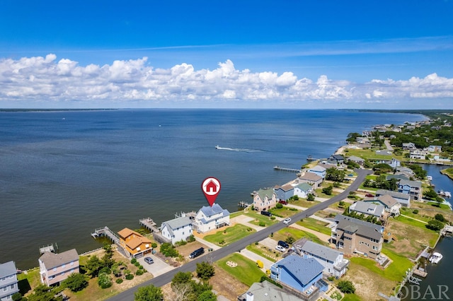 drone / aerial view with a water view and a residential view