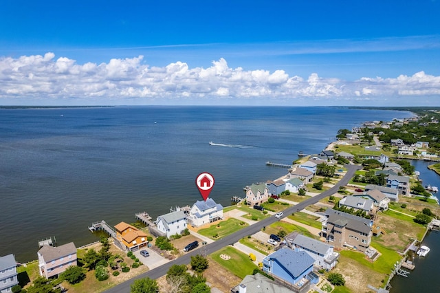birds eye view of property with a water view and a residential view