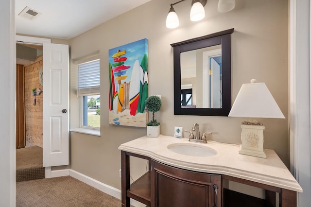 bathroom with vanity, visible vents, and baseboards