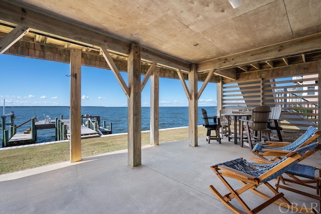 view of patio / terrace with a water view and a boat dock