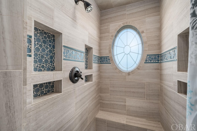 full bath featuring tiled shower