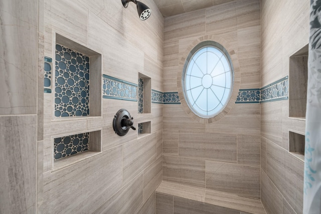 full bath with a tile shower