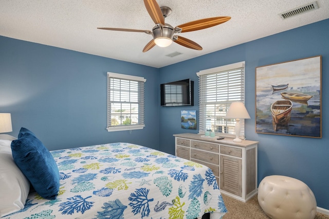 bedroom with light colored carpet, multiple windows, and visible vents