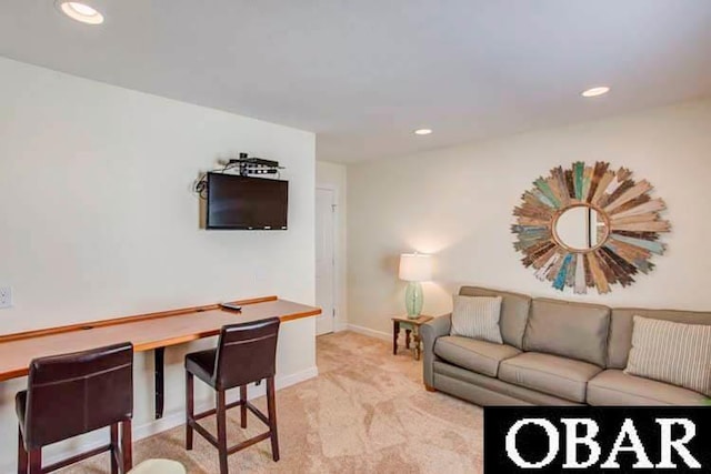 living room featuring recessed lighting, light colored carpet, and baseboards