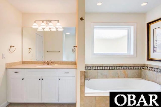 bathroom with a garden tub and vanity