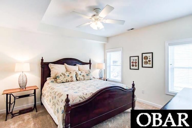 bedroom with ceiling fan, carpet flooring, visible vents, and baseboards