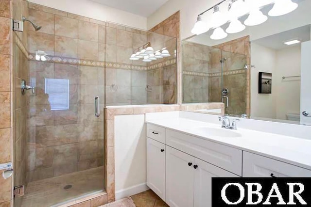 bathroom featuring a stall shower, tile patterned flooring, and vanity