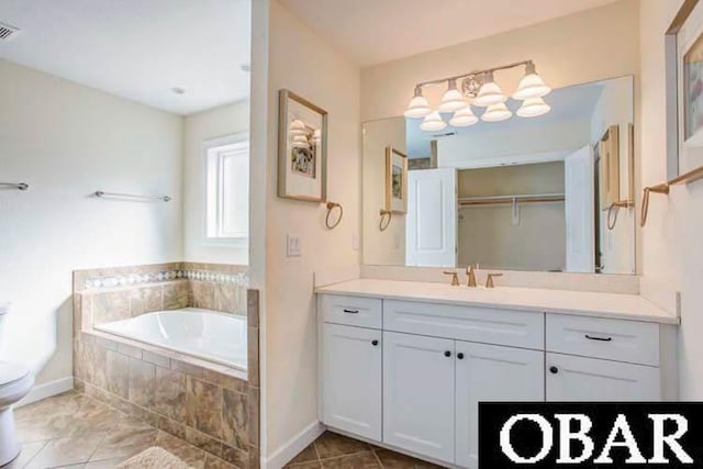 full bath featuring toilet, visible vents, vanity, a bath, and tile patterned floors